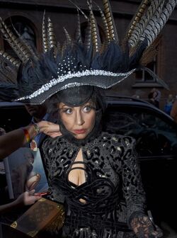 Lady Gaga comes a cropper in Louis Vuitton feather headdress