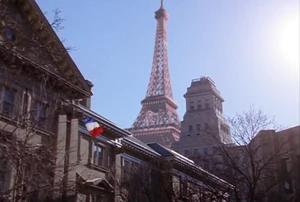 Operations and Michael emerge at street level in Paris, near the Eiffel Tower.