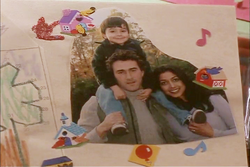 Nikita looks at a photo of Michael with his family.