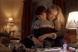 Nikita and Adam look through a family photo album.