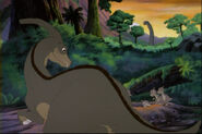 Screenshot of a background character; a mother Parasaurolophus with her children. While the children's crests are similar in length to Ducky's, the mother's is of a more accurate Parasaurolophus length. Both the mother and the children also have slim jawlines.