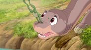 A frog jumps on Littlefoot's head