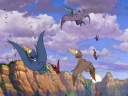 The blue, cyan, and purple pterosaur above the brown Pteranodon flapling