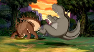 The Tyrannosaurus gets swatted away by the Stegosaurus