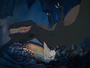 Sharptooth gets up from the huge fall.