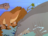 The sharptooth attacks the log and misses.
