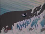 The first marine reptile passes by a shoal of fish