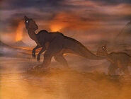 Some dinosaurs wander through a hellish landscape