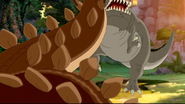 The T. rex is smashed by the tail of the Stegosaurus
