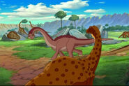 An example of a variety of longneck (in the foreground) that has no known official classiciation. Several fans believe this variety may be a depiction of Saltasaurus.