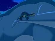 Sue taking Littlefoot to her face with her tail