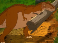 The sharptooth prepares to throw the log