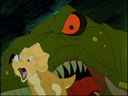 Mama Sharptooth scaring Littlefoot, Cera and Chomper (the latter is offscreen) into a small cave