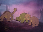 A signed cel of Littlefoot, Cera and Spike turn around to see that Petrie is still alive.