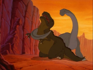 Grandpa Longneck fights the sharptooth.