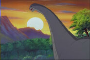 Grandma Longneck, observing the setting sun while singing her lullaby to Littlefoot.