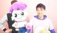 Justin holding a plushie of himself