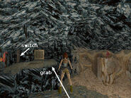 From here, you can see how Lara's doppelganger has mimicked her movements using the tan blocks on the other side of the room. Now take a running jump to grab the right side of the raised platform ahead. Pull up. Here you'll see a switch, a trapdoor in the floor and the exit door. Pull the switch to open the trapdoor above a lava pit. You have a little over 40 seconds before the trapdoor closes. So you don't need to rush, but don't dawdle either.