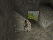 Inside is a small room with a slope that meets the floor, 3 angled blocks and a small ledge above. Position Lara with her back to the slope and her chest against the side of the lowest angled block, as shown above.