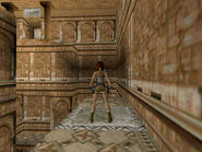 Until Lara steps off the pad, the timer won't start. So take all the time you want to get her into position: Turn so the central structure is on Lara's left and her feet are on the back edge of the pad (as shown above). Make sure her health bar is at least half full, since she'll lose some in the process, and save your game if you can. Now comes the speed run: Hold the Action key and take two hops back to drop and hang from the edge.