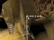 To get down, walk to the edge of the invisible platform nearest the sphinx. Set Lara up for a running jump, aiming for the bottom left corner of the sphinx's headdress (i.e., walk to the edge, adjust her angle and hop back once). Then take that running jump. Lara will land on the side of the sphinx and start to slide. Press Action to grab the edge.