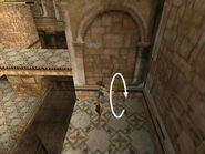 As Lara falls, press and hold Roll, so that when she hits the ledge, she rolls and comes up facing in the opposite direction.