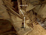 Step to the right a bit and then take a standing jump to land near the cave opening. Inside you'll find secret #1.