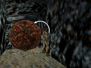 Face the wall on the right, so the boulder is on Lara's left. Adjust her position so she's flat against the wall (as shown above). Side flip to the left toward the boulder.