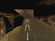 After placing the two Ankhs in the receptacles on top of the sphinx, climb back onto the sphinx's headdress on the right side (when facing the rear of the sphinx). Turn right and walk out to the corner overlooking the rocky cave wall. Turn around so Lara is facing the top of the sphinx's head (as shown above).