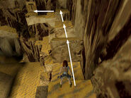 Now turn so the cave wall is on Lara's right. Climb or jump onto the angled block ahead. Then jump the gap to land on the next flat block. Do the same again and continue down and to the left to the switch.