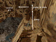 Jump over the angled block and immediately jump again to land on the rocks ahead. Lara will slide down to a flat spot in the corner. Turn left and walk/slide down to the items on the rock ledge, secret #1.