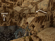 Climb out of the water on the right (where Lara is standing in the screenshot above). Climb onto the rocks (on the right in this screenshot). Walk forward (with the pool on your left) until Lara won't walk farther.