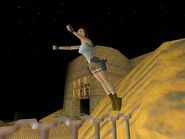 Hold Jump + Left to make Lara hop off the angled top of the yellow rock...