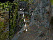 Once on top of this rock, turn left and position Lara near the middle of the block, a step or so back from the edge of the next block, which juts upward. (If Lara's feet are right against this edge, she won't be able to jump forward.) Then take a standing jump forward to grab the edge of the higher block ahead. Pull up.