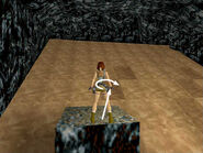 Take a running jump over the spikes to the nearest flat spot. Press the right direction key to pivot in the air so Lara lands on the flat spot facing the far wall. If you make it this far without stumbling, save your game if possible. Then, if you mess up, you can just reload and skip the business with the lever and the swimming.