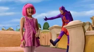 Stephanie laughs as Robbie can't control his feet.