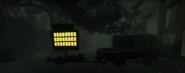 A digital traffic sign's default message working off battery power while shorting out in the dark rain. It is also seen attached to the pickup truck.
