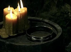 A Rada'Han seen on a silver plate with candles