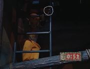 Nick goes down the ladder, unaware that a half pendant hangs there.