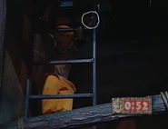 Nick Borey from Henry VIII's Great Seal climbing down into the Dungeon. The other half of his pendant is circled.