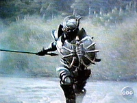 Zeltrax wielding a sword in his left hand and a shield in his right hand.
