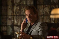 Aldrich Killian contacting his boss Johan Liebert on his cellphone.