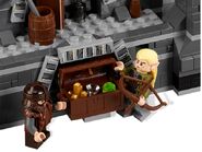 Gimli and Legolas with a treasure chest next to the back door of Balin's tomb