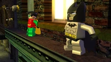 Batman and Robin scale a building in Gotham