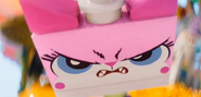 A frame from the movie where Unikitty briefly has her normal color but with her "rage" face