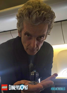 Peter Capaldi holding a miniature LEGO Tardis (from the 71204 Doctor Who Level Pack)