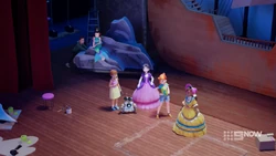 Ethan pushing Vicky and her rock onto the stage.