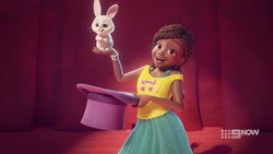 Andrea pulling a bunny out of a hat.