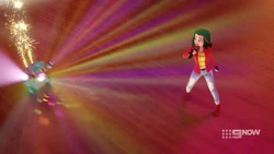 Vicky is pleasantly surprised that Zobo is providing fireworks for her song.