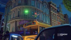 Mia directing traffic (how did she get on top of the bus?)